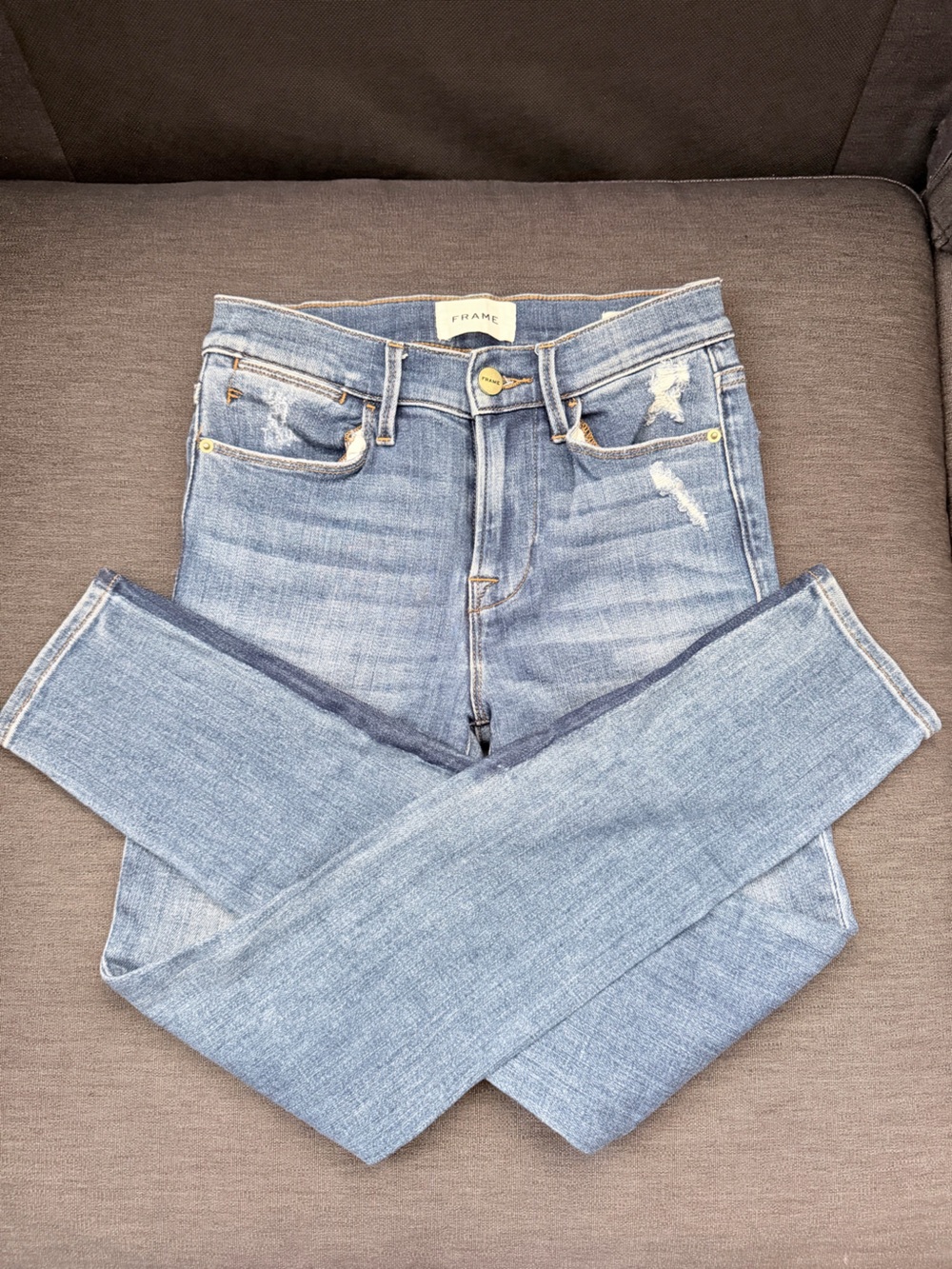 Frame Denim Light Wash High-Rise Skinny Jeans with Distressed Accents